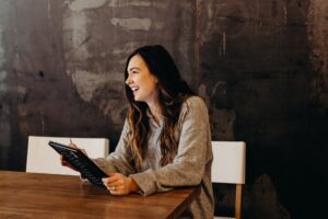 Woman smiling with tablet - engagement marketing