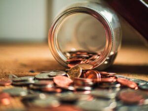 jar of coins spilled over- ecommerce strategy - digital nomad designs